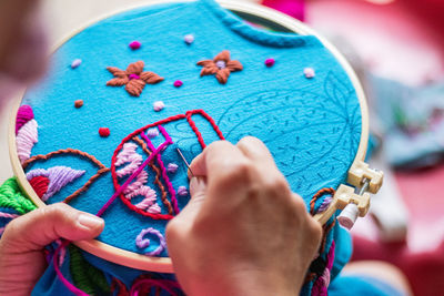 Close-up of hand making embroidery