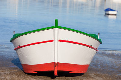 Close-up of red umbrella on beach