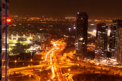High angle view of illuminated buildings in city at night