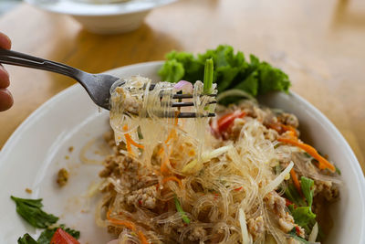 Close-up of thai food spicy salad with glass noodles in plate on table