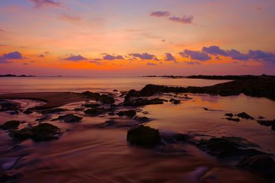 Scenic view of sea against romantic sky at sunset