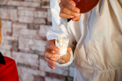 Midsection of man holding ice cream