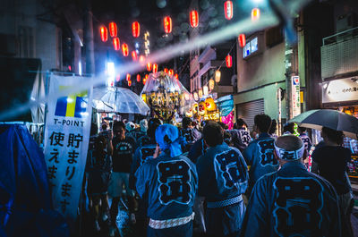 Crowd on street in city at night