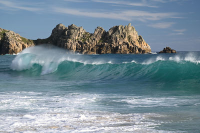 Scenic view of rocks in sea against sky
