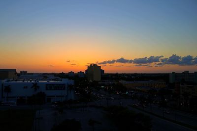 High angle view of silhouette buildings against sky during sunset