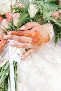 Midsection of woman holding flower bouquet