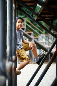 Full length portrait of happy boy in playground