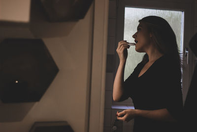 Side view of woman looking at home