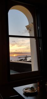 View of sea seen through glass window
