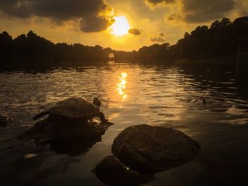 Scenic view of lake against sky during sunset