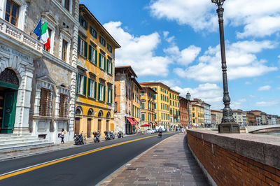 Street amidst buildings against sky in city