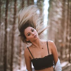 Portrait of woman standing in forest
