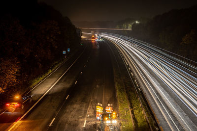 High angle view of light trails on road at night