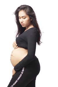 Young woman standing against white background