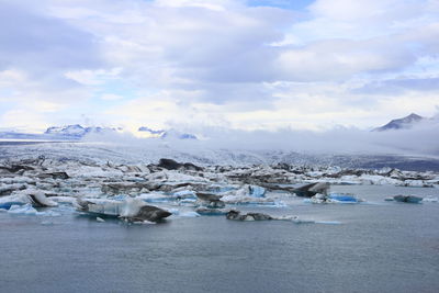 Scenic view of lake against sky during winter