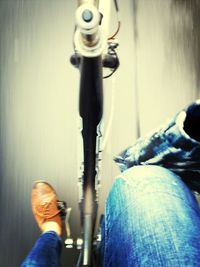 Low section of person standing on tiled floor