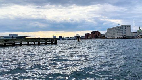 Panoramic view of sea and buildings against sky