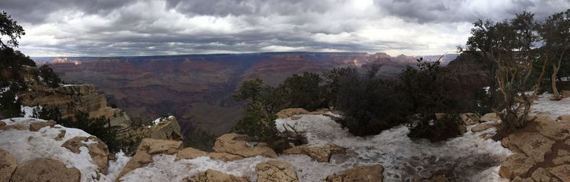 Panoramic view of trees and mountains against sky