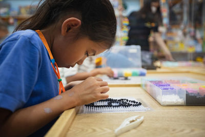 Girl looking at camera on table