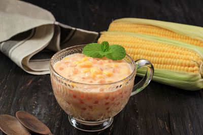 Bubur jagung mutiara, indonesian traditional porridge on wooden table 