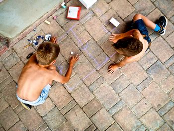 High angle view of couple sitting on street