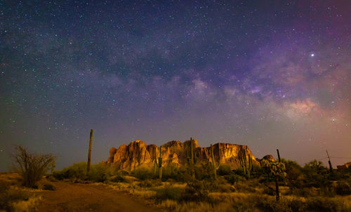 Scenic view of rock formation against sky at night