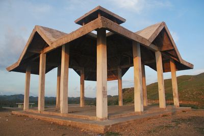 Built structure on landscape against sky