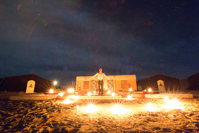 Illuminated building against sky at night