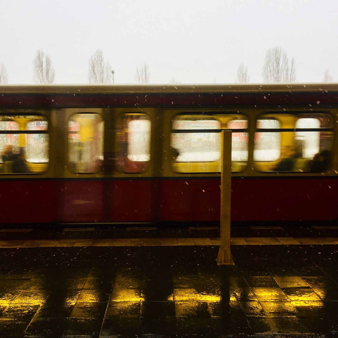 TRAIN ON RAILROAD STATION PLATFORM