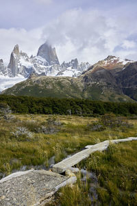 Scenic view of mountains against cloudy sky