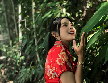 Side view of a smiling young woman looking away