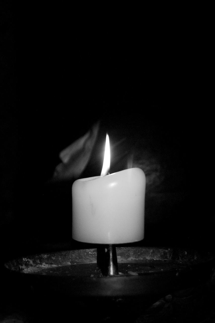 CLOSE-UP OF CANDLES IN DARKROOM