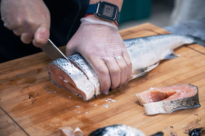 Cropped hands of chef preparing food on table