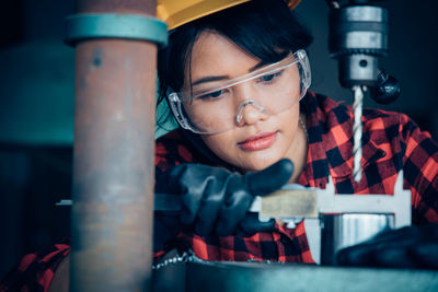 Portrait of young woman working in container