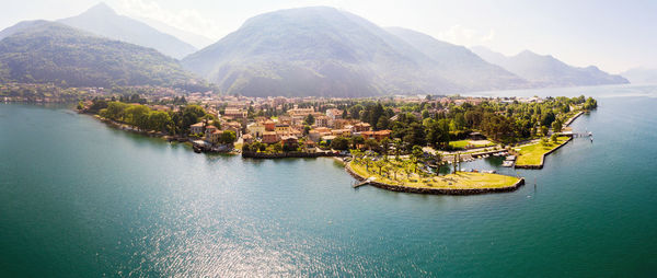 Aerial view of townscape by sea against sky