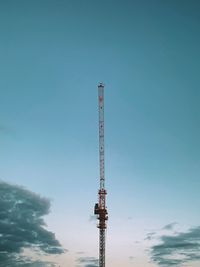 Low angle view of crane against clear blue sky