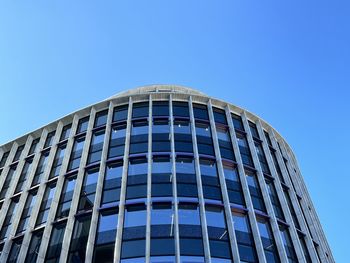 Low angle view of modern building against clear blue sky