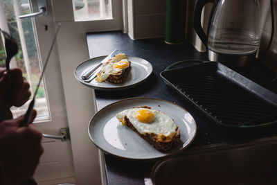 Cropped hand of person preparing food on table