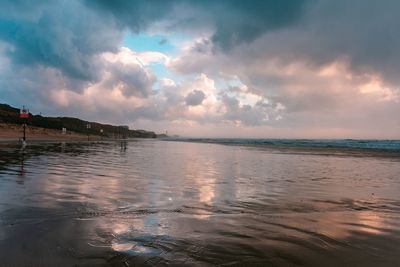 Scenic view of beach against sky during sunset