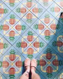 Low section of woman standing on tiled floor