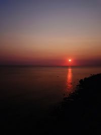 Scenic view of sea against romantic sky at sunset