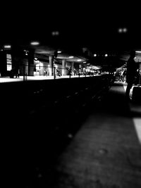 People walking on city street at night