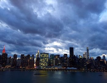 Cityscape against cloudy sky