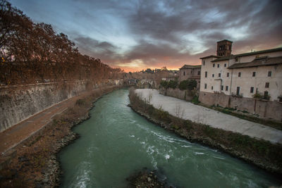 Scenic view of river against sky at sunset