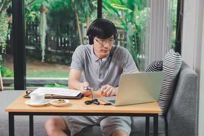 Young woman using laptop at home