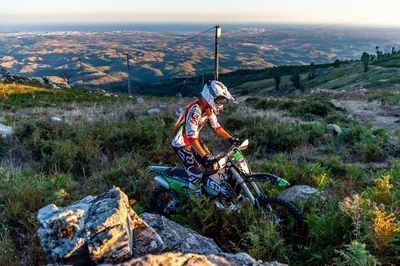 Man riding motorcycle on rock at mountain