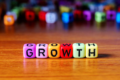 Close-up of text on multi colored toy blocks table