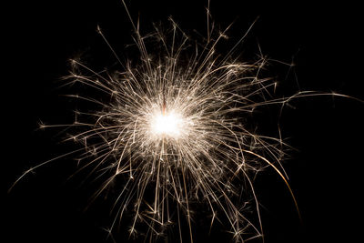 Low angle view of firework display at night