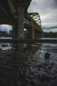 Close-up of bridge over river against sky