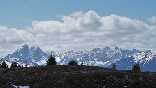 Scenic view of snow covered mountains against sky